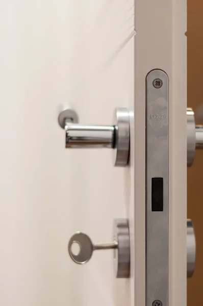 Modern, contemporary satin handle on a wooden door — Stock Photo, Image