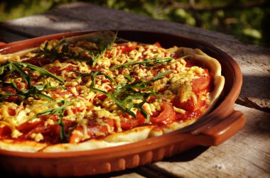 Ev yapımı pizza domates, fesleğen ve salam ızgarada yapılan kaba