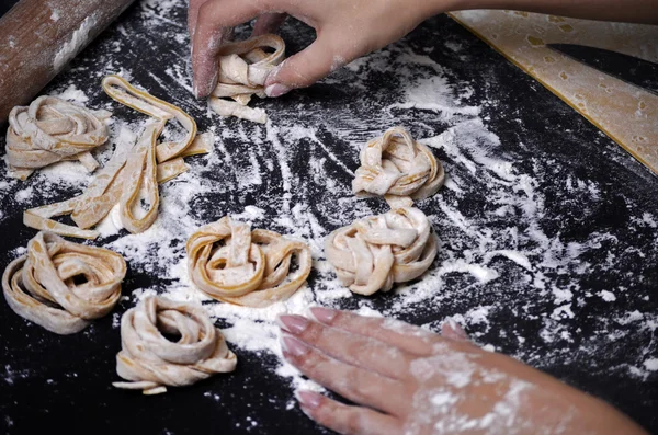 Genç bir kadın makarna hamur el ile kneads