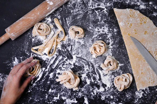 Una joven amasa masa de pasta a mano —  Fotos de Stock