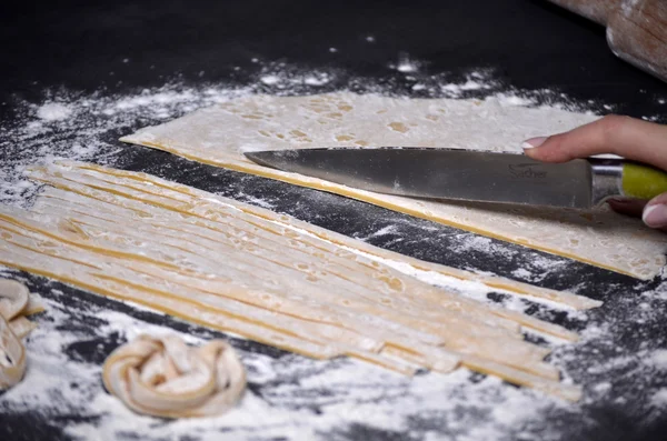 Genç bir kadın makarna hamur el ile kneads