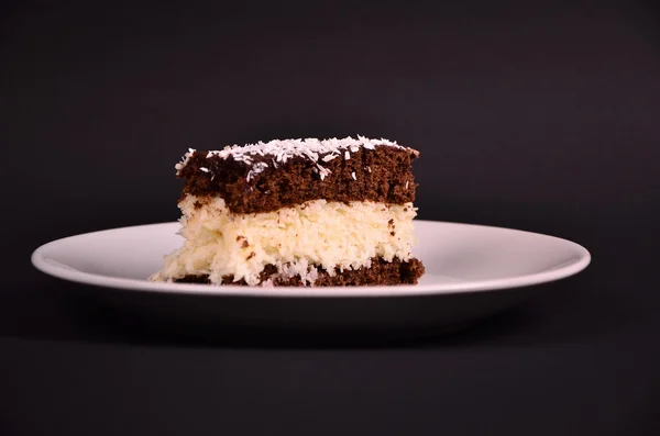 Cake bounty on white tale on black table — Stock Photo, Image