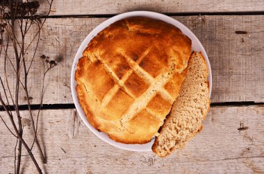 Fırından yeni çıkmış bir rustik ahşap masaya servis ekşi hamur çavdar ekmeği somun.