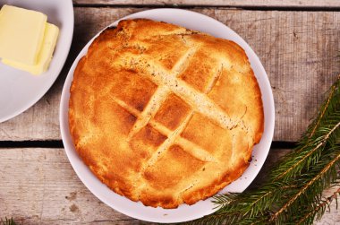 taze ev yapımı ekmek yağı ile beyaz bir tabak bir tabak yanındaki ahşap bir masa üzerinde yatıyor. Noel