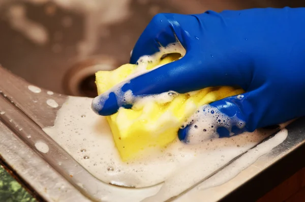 Woman washing the dishes in the kitchen sink area - closeup on hands — Stock Photo, Image