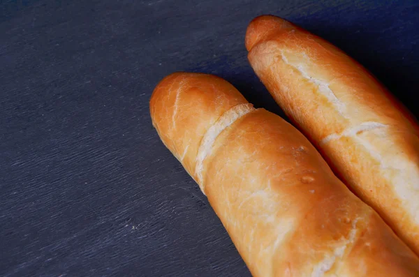 Fresh  baguette on wooden table, close up — Stock Photo, Image