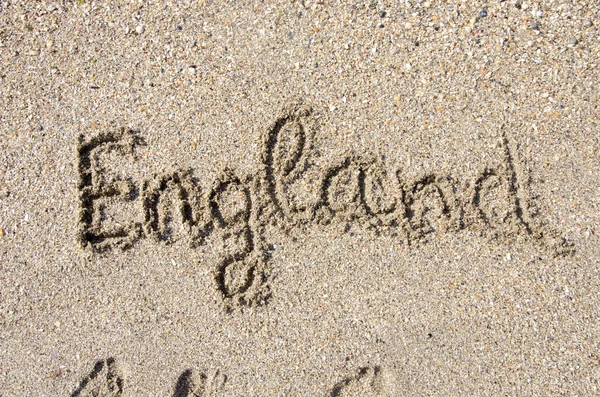 The word .eu handwritten in sand on a beach, ideal for internet or conceptual designs background with feet metaphor for communication, speech, message, mail, dialog, talk, contact, email, internet