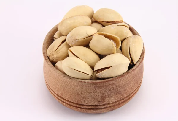 Pistachio in a round wooden form — Stock Photo, Image