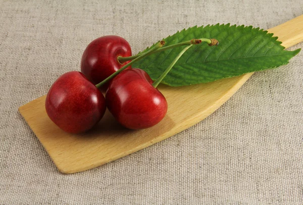 Abstract view cherry on wooden spatula — Stock Photo, Image