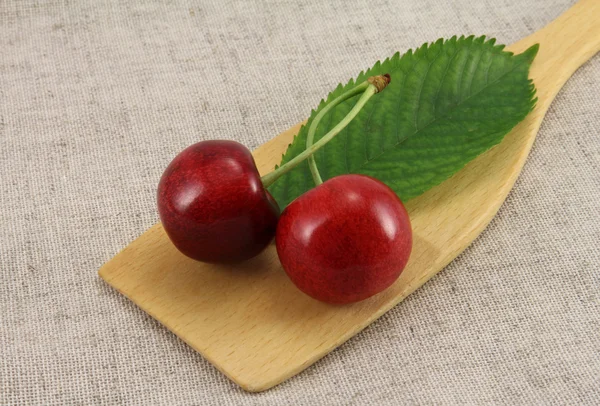 Abstract view cherry on wooden spatula — Stock Photo, Image