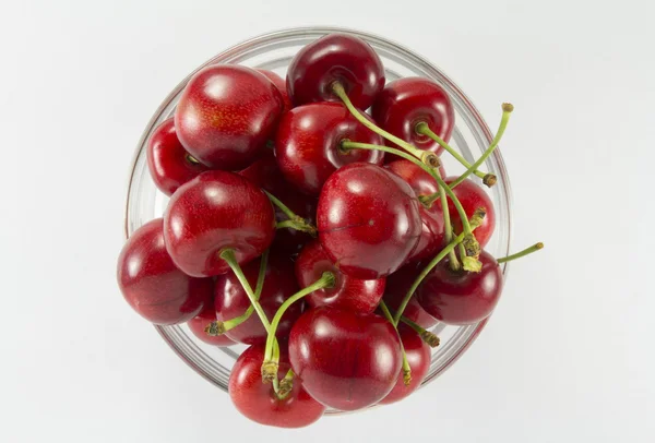 Cherries (red)  in a round glass salad bowl 