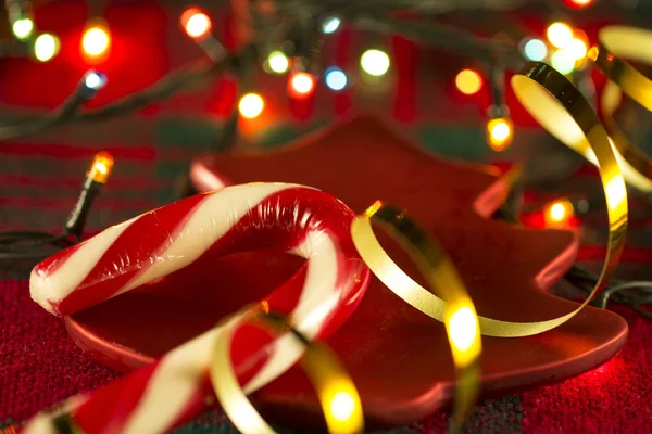 Candy Cane på en bakgrund av jul dukar och jul kransar — Stockfoto