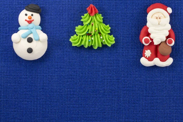 Christmas figurines sweet mastic on a blue background — Stock Photo, Image