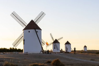 Mota del Cuervo, İspanya; 22 Eylül 2025: Altın saat boyunca Mota del Cuervo tepesinde duran yel değirmenleri, Cervantes 'in Don Kişot' unu sembolize ediyor.