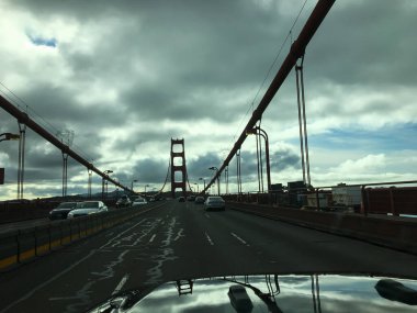 San Francisco, ABD; 4 Ocak 2020: Bulutlu bir gökyüzü altında Golden Gate Köprüsü 'nde seyahat eden araçlar