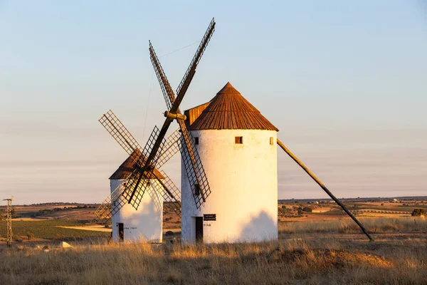 Geleneksel bir manzarayı ön plana çıkaran, akşam gökyüzüne karşı tarihi İspanyol yel değirmenleri