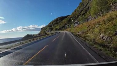 Bakış açısı, güneşli bir günde Norveç 'te bir sahil yolunda bir karavan sürerken çekilmiş.