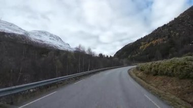 Bakış açısı, güneşli bir günde Norveç 'te bir sahil yolunda bir karavan sürerken çekilmiş.