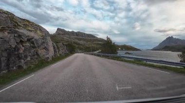 Güneşli bir günde Lofoten Adaları 'nın güzel manzarası olan bir dağ yolunda karavanla yolculuk yapmak.