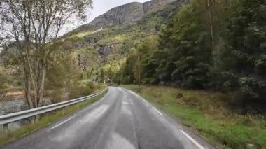 Lofoten Adaları, Norveç; 11 Eylül 2024: Güneşli bir günde Norveç 'te manzaralı bir yolda giden bir karavanın bakış açısı