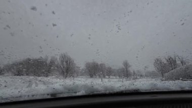 İspanya 'nın La Molina şehrinde kış boyunca virajlı ve karlı bir yolda giden bir arabadan bakış açısı