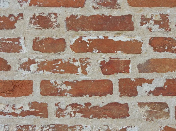 Oude rode bakstenen muur met shabby paint. — Stockfoto