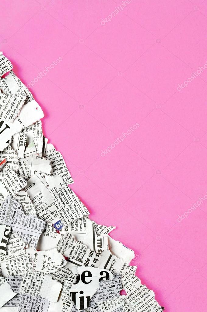 Shredded newspaper pieces in bottom left corner on a dark pink surface.