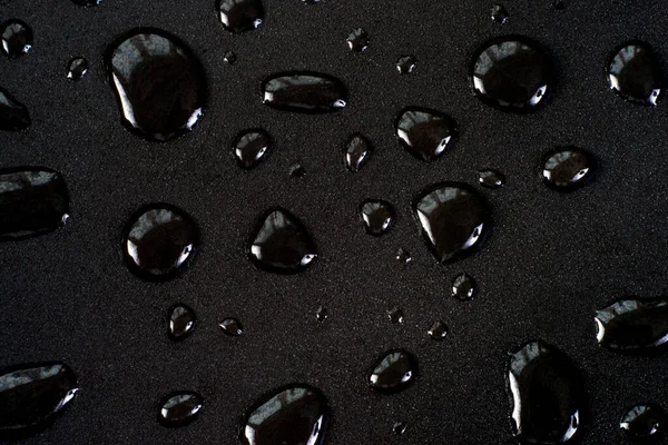 Drops of water on a black matte surface