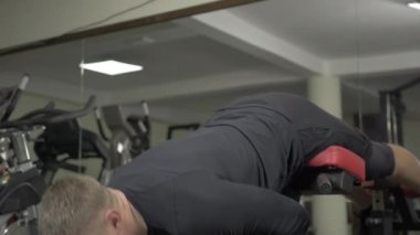 Jimnastik salonunda Roma sandalyesi üzerinde aşırı uzatma egzersizi.