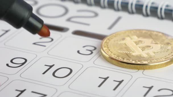 Bitcoin και κόκκινο σήμα κύκλου σε ένα χάρτινο ημερολόγιο — Αρχείο Βίντεο