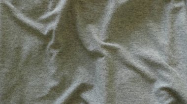 Yüzeyinde pürüzsüz katları olan buruşuk gri pamuk kumaş, gündelik kumaş çizgileri olan kül renkli kumaş, dalgalı maddenin açık katı renkli desteği, tek renkli tuvalin boş dokusu