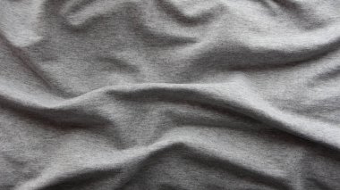 Gri dalgalı kumaş arkaplan, hafif özensiz üst çerçeve tam çerçeve, kül rengi minimalist tek renkli fon malzemesi, buruşmuş düz pamuk yüzey örtüsü.
