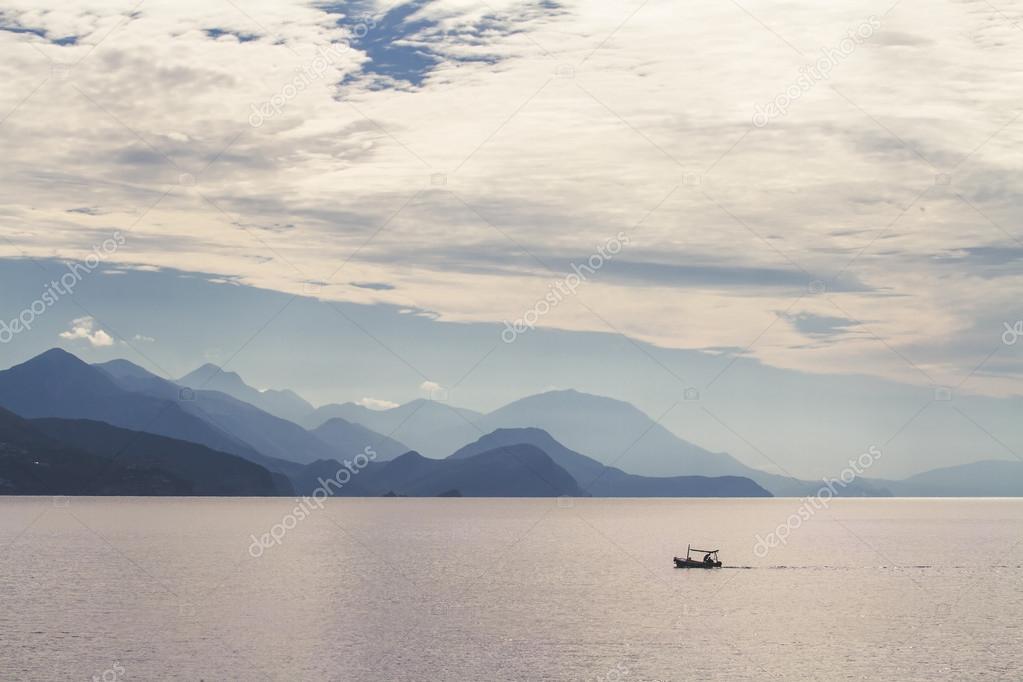 Sea, mountains and a fishermen boat.