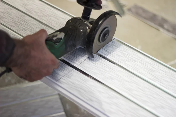 Cutting plastic with a grinding machine — Stock Photo, Image