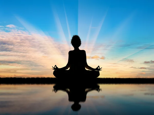 Silhouette of a girl practicing yoga — Stock Photo, Image