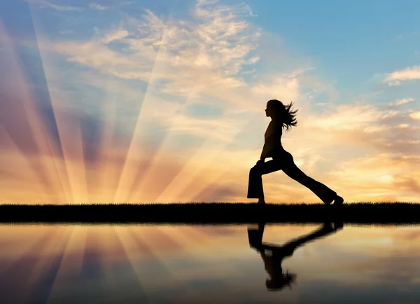 Silhouette of a girl practicing yoga — Stock Photo, Image