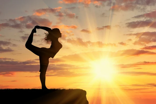 Silhouette of a girl practicing yoga — Stock Photo, Image