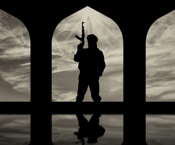 Silhouette of a terrorist with a gun — Stock Photo, Image