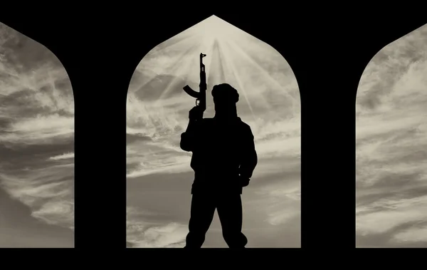 Silhouette of a terrorist with a gun — Stock Photo, Image