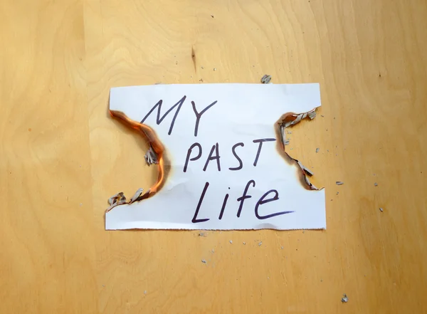 Burning a piece of paper with the inscription — Stock Photo, Image