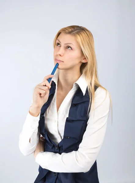 Thinking business woman with a pen in hand — Stock Photo, Image