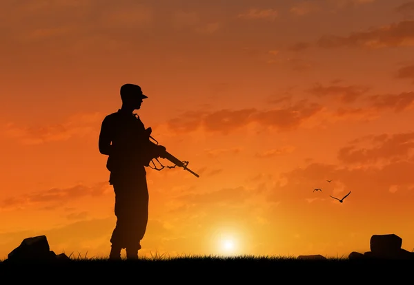 Silhouette of a terrorist with a weapon — Stock Photo, Image