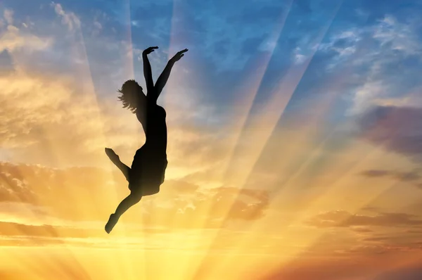 Happy woman jumping at sunset — Stock Photo, Image