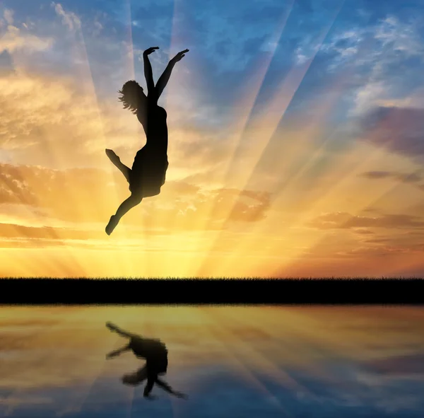 Happy woman jumping at sunset — Stock Photo, Image