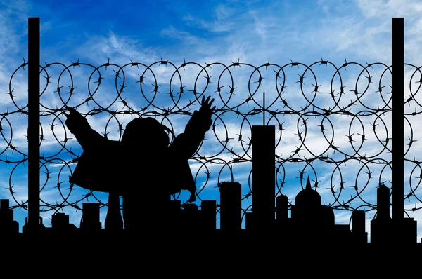 Silhouet vluchteling hek — Stockfoto
