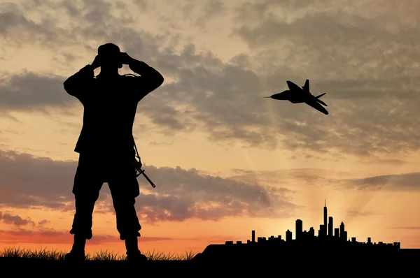 Silhouette of a soldier and an airplane — Stock Photo, Image