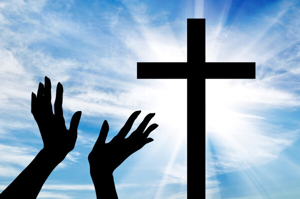  Silhouette of hands outstretched on the cross 