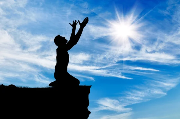 Silhouette of man praying — Stock Photo, Image