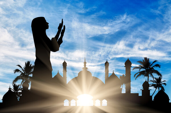 Silhouette of praying woman Stock Image