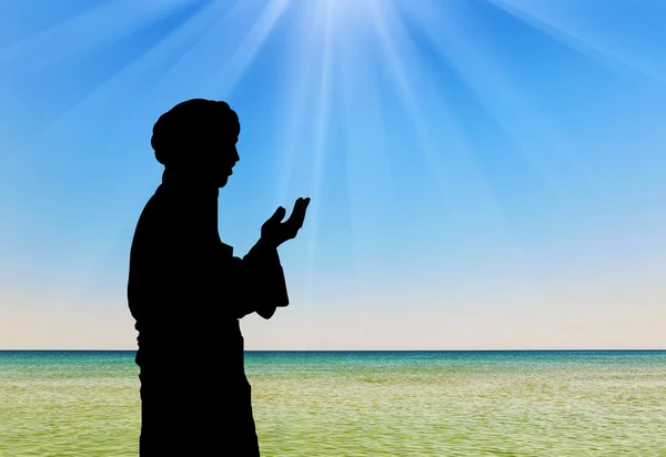 Silhouette of man praying — Stock Photo, Image